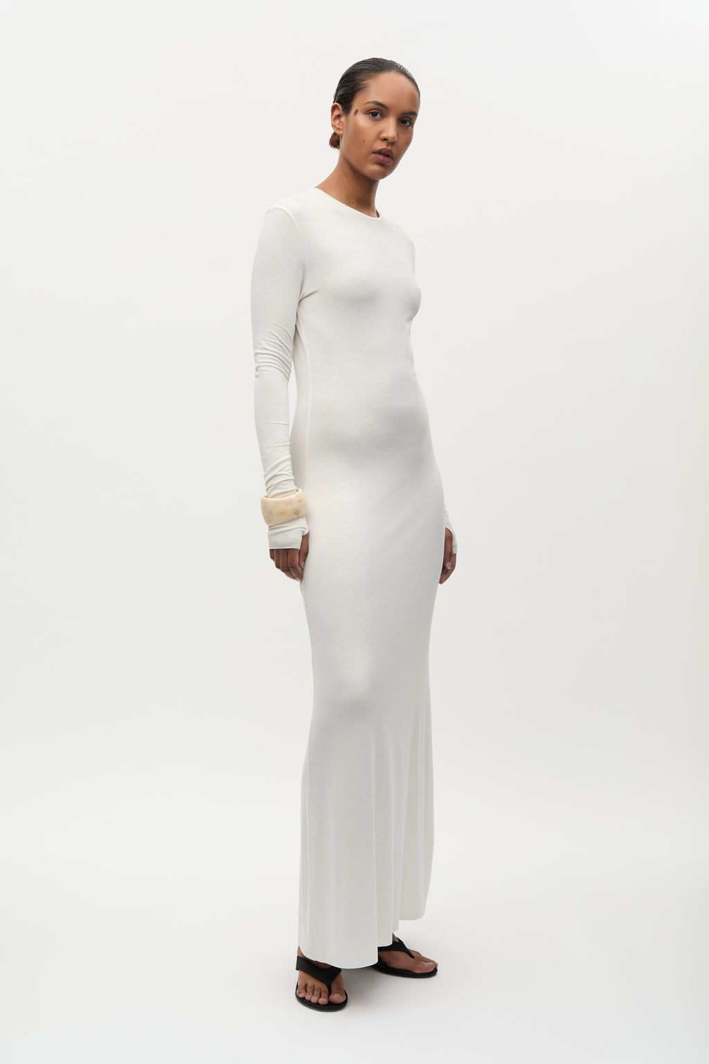 Woman wearing a white dress on a white background