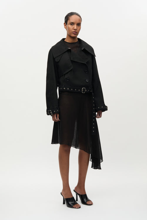Woman wearing a black coat and skirt set on a white background