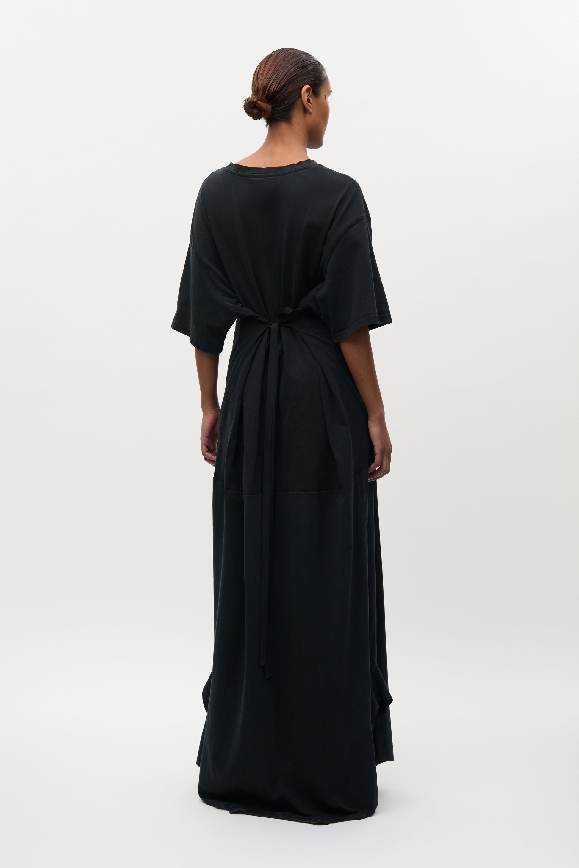 Woman wearing a black dress with a white background