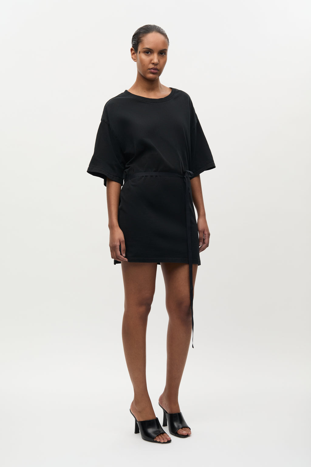 Woman wearing a black dress on a white background
