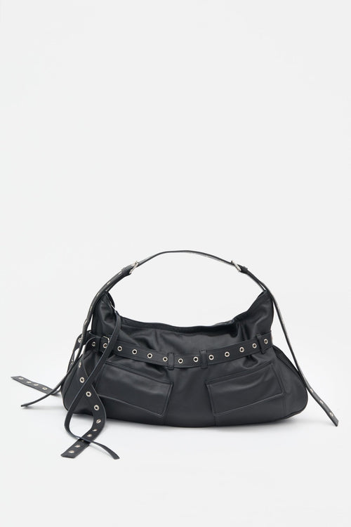 Black leather handbag with decorative elements on a white background