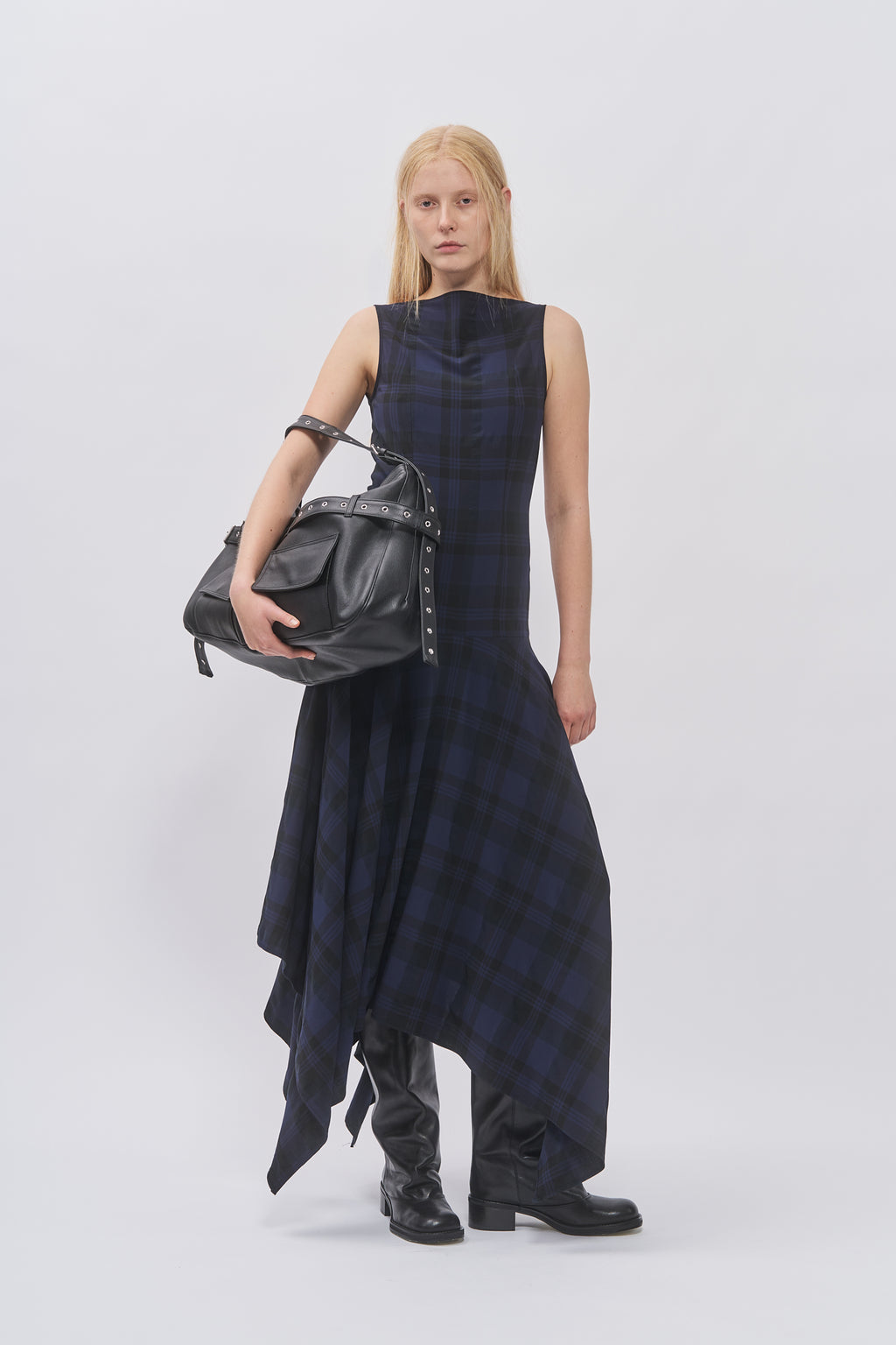 Taus Asymmetrical Dress in navy and black check, sleeveless with handkerchief hem, styled with the black leather Juho Bag