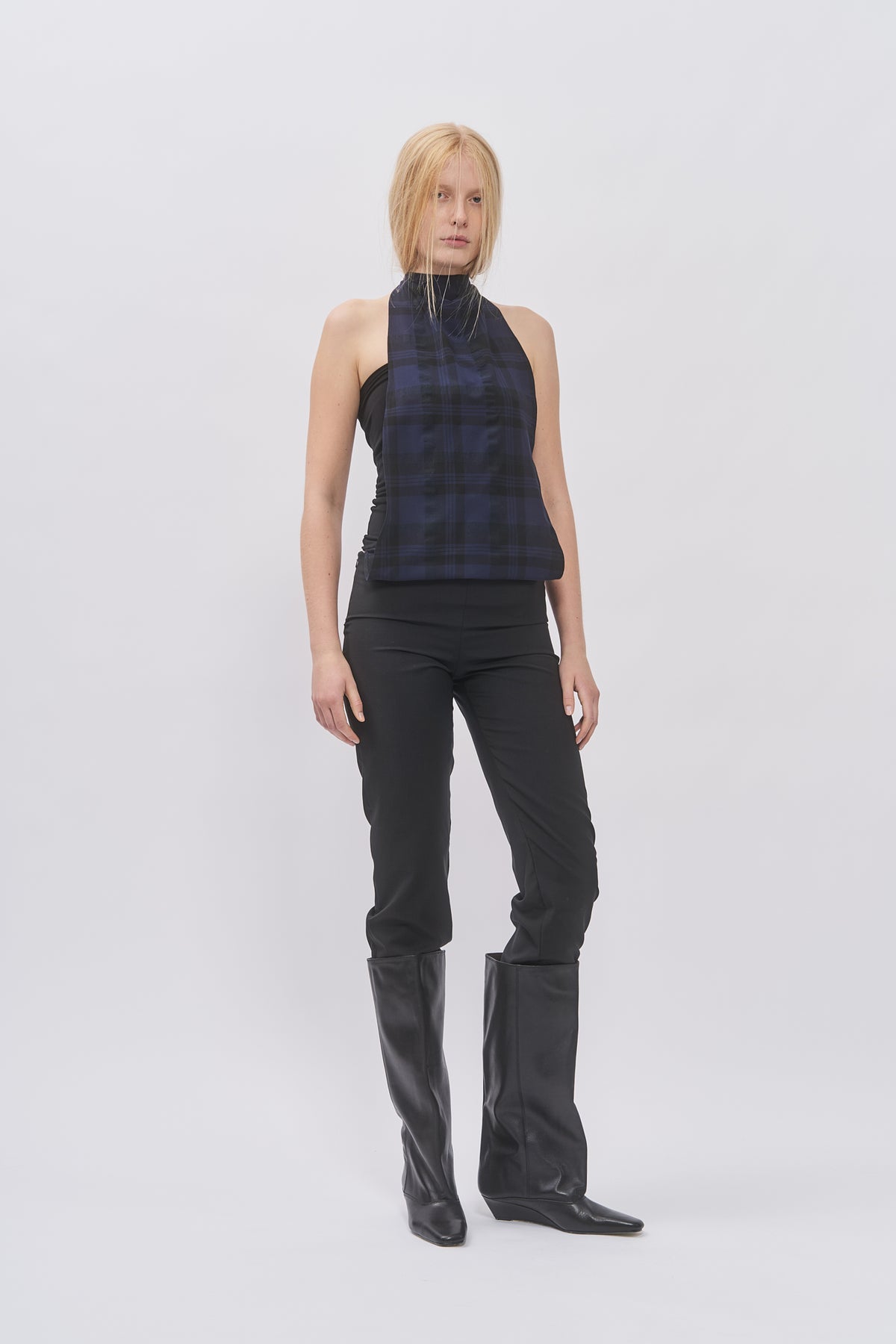 Taus Two-Layer Halterneck Top in navy and black check, worn with black slim trousers and knee-high boots