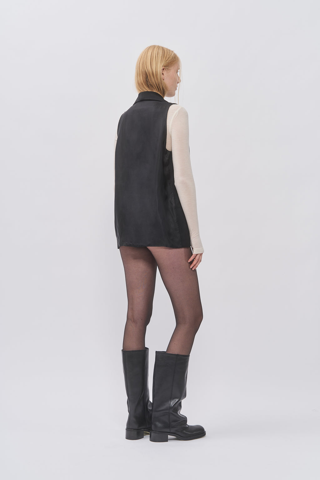 Side-back view of Taus Long Waistcoat in black, a longline sleeveless tailored waistcoat