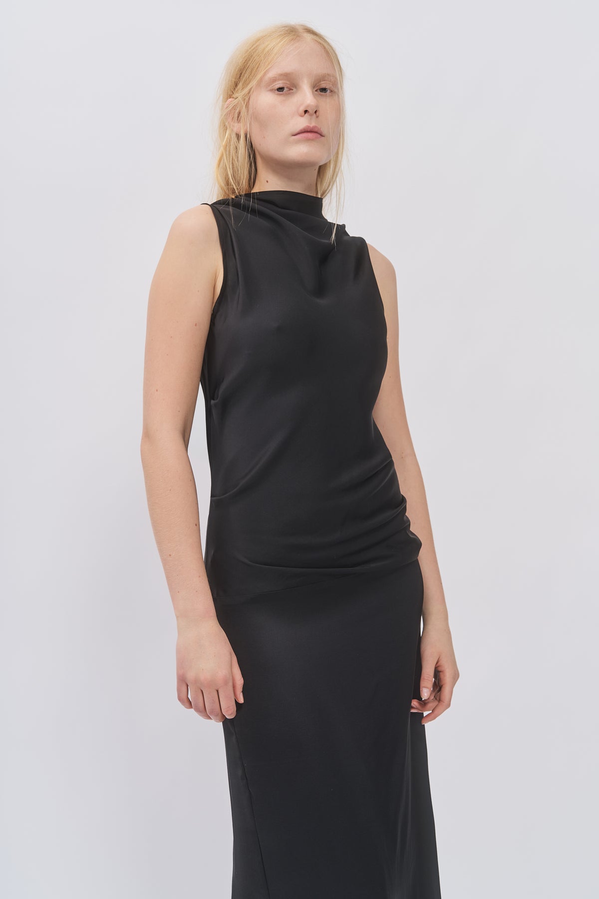 Close-up of Taus Open-Back Dress in black showing the draped high neck and fitted bodice