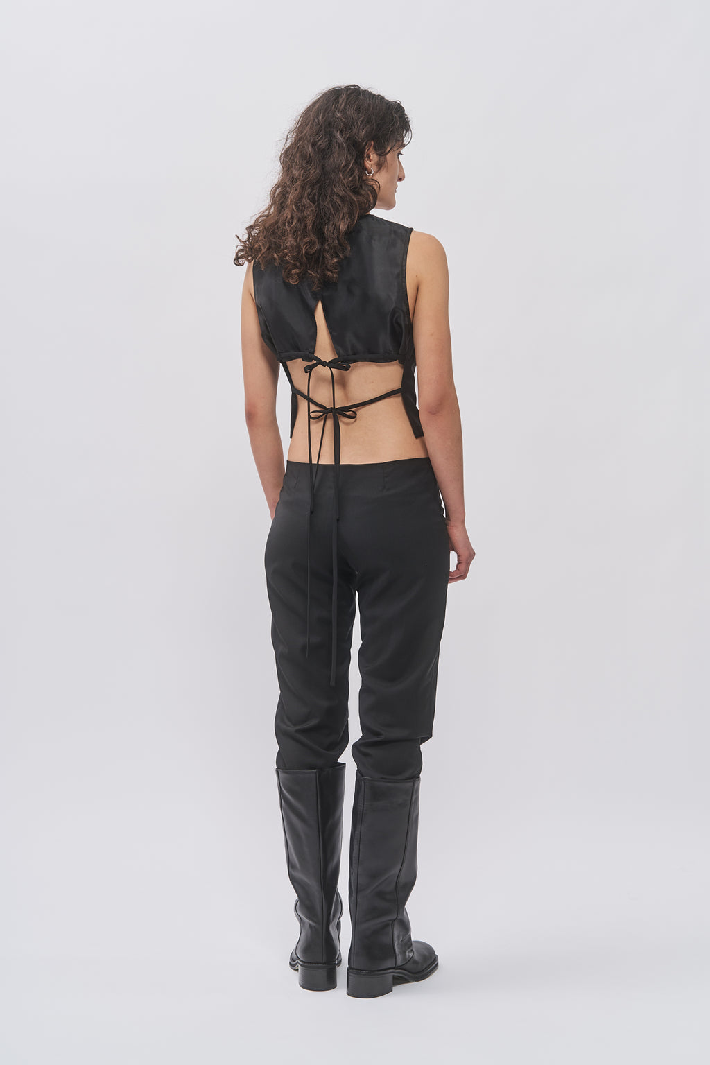 Back view of Taus Open-Back Waistcoat in black with cut-out back and tie closure