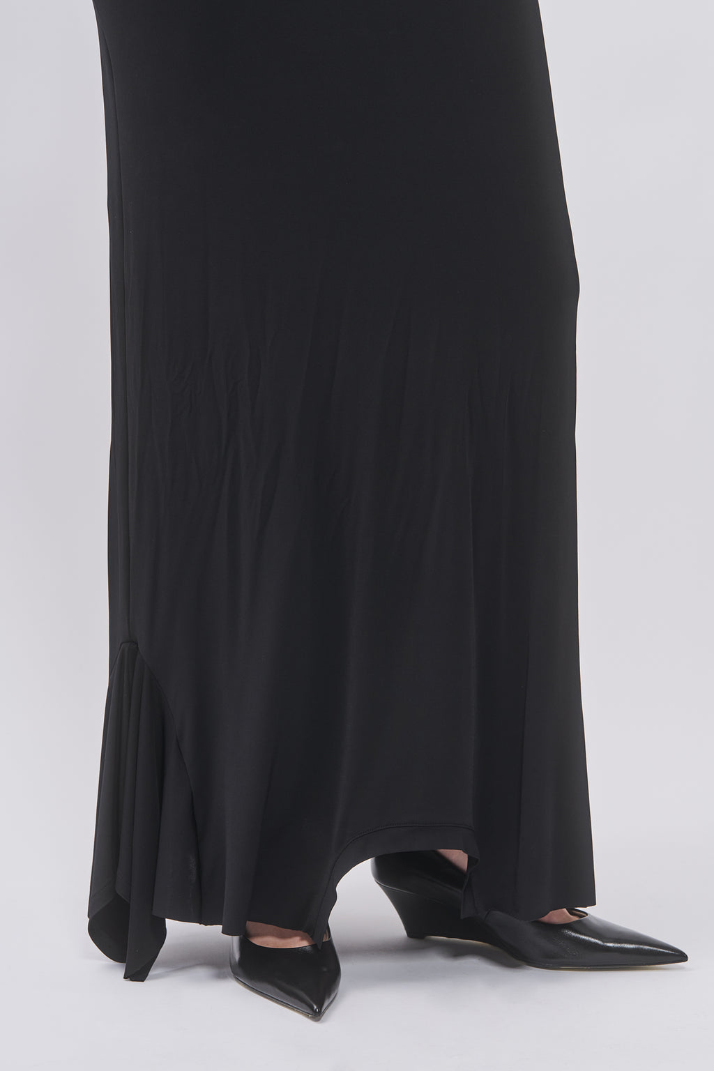 Hem detail of Taus T-Shirt Hem Dress in black showing the asymmetric flared hem