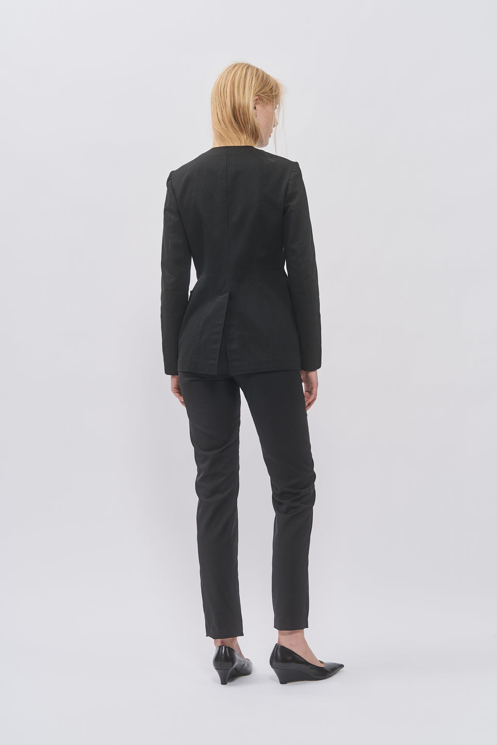 Back view of Taus Tailored Jacket in black showing the fitted, shaped silhouette