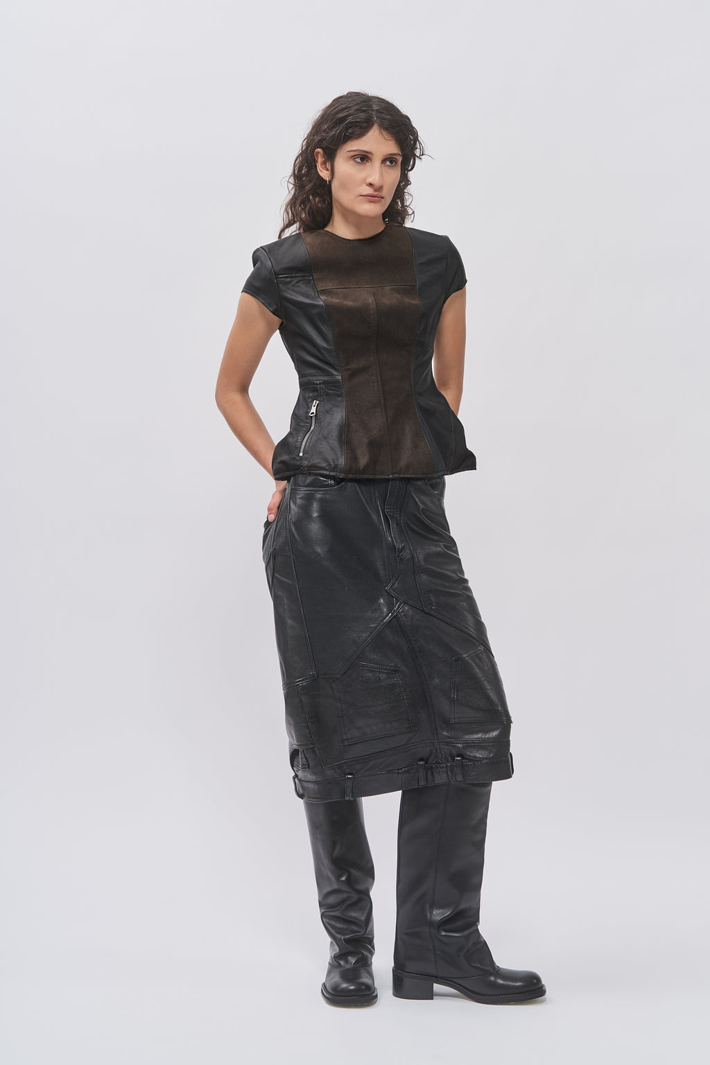 Taus Upcycled Leather Top in black, short-sleeve panelled top, worn with a black leather skirt and boots