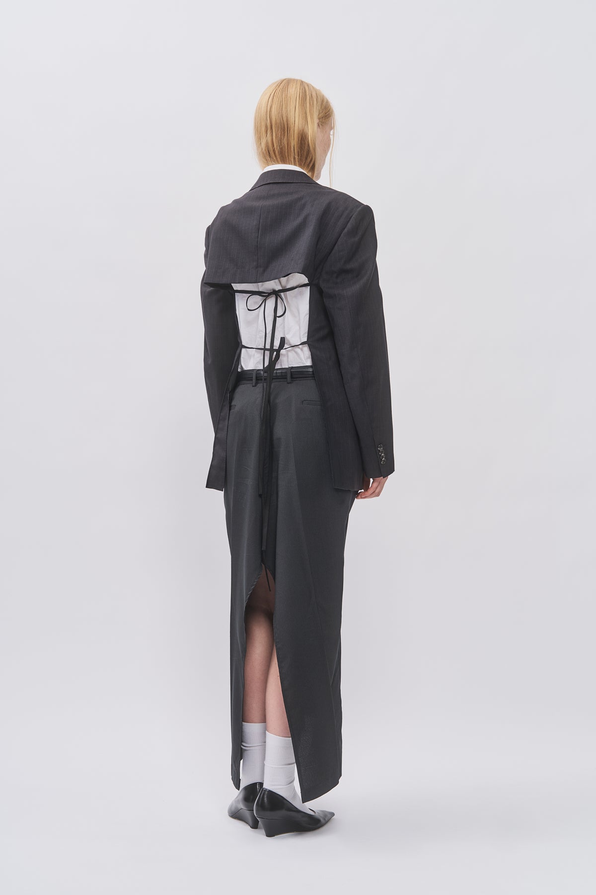 Back view of Taus Upcycled Open-Back Blazer in charcoal grey with open back and black ties