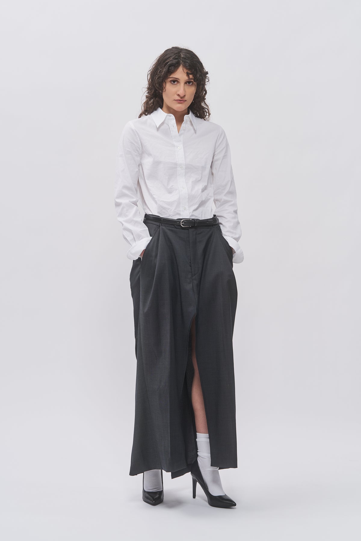 Taus Upcycled Suit Skirt in charcoal grey, maxi skirt with front slit, styled with a white shirt and belt