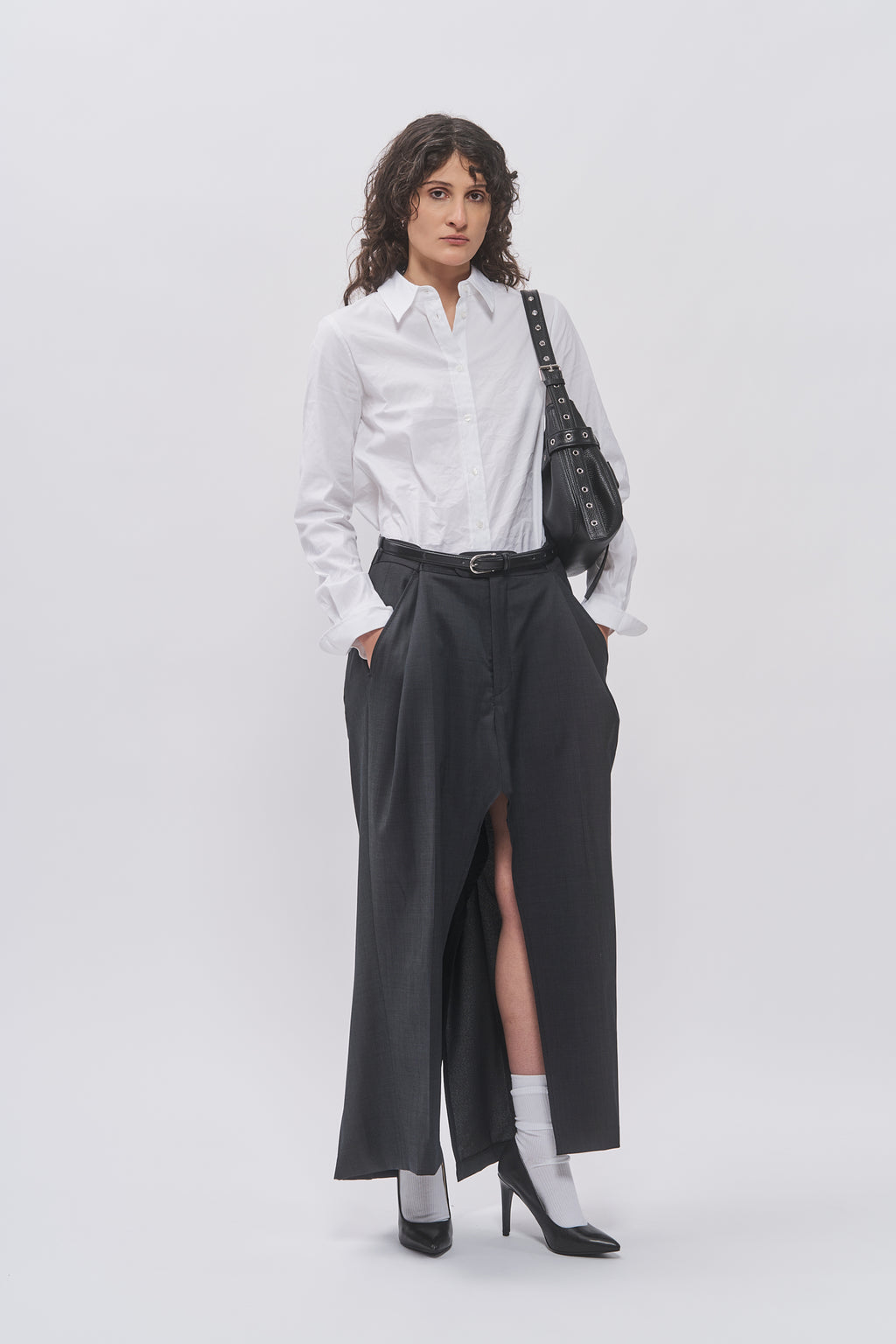 Taus Upcycled Suit Skirt in charcoal grey with front slit, styled with a white shirt and black Juho Bag