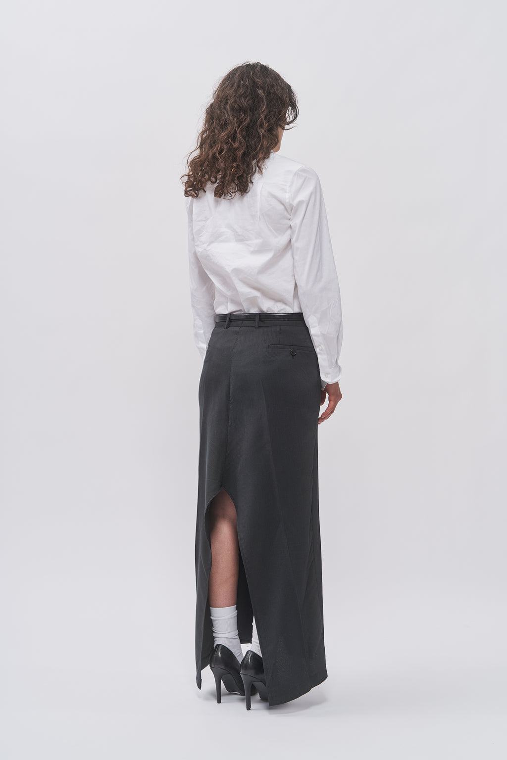 Back view of Taus Upcycled Suit Skirt in charcoal grey with high back slit