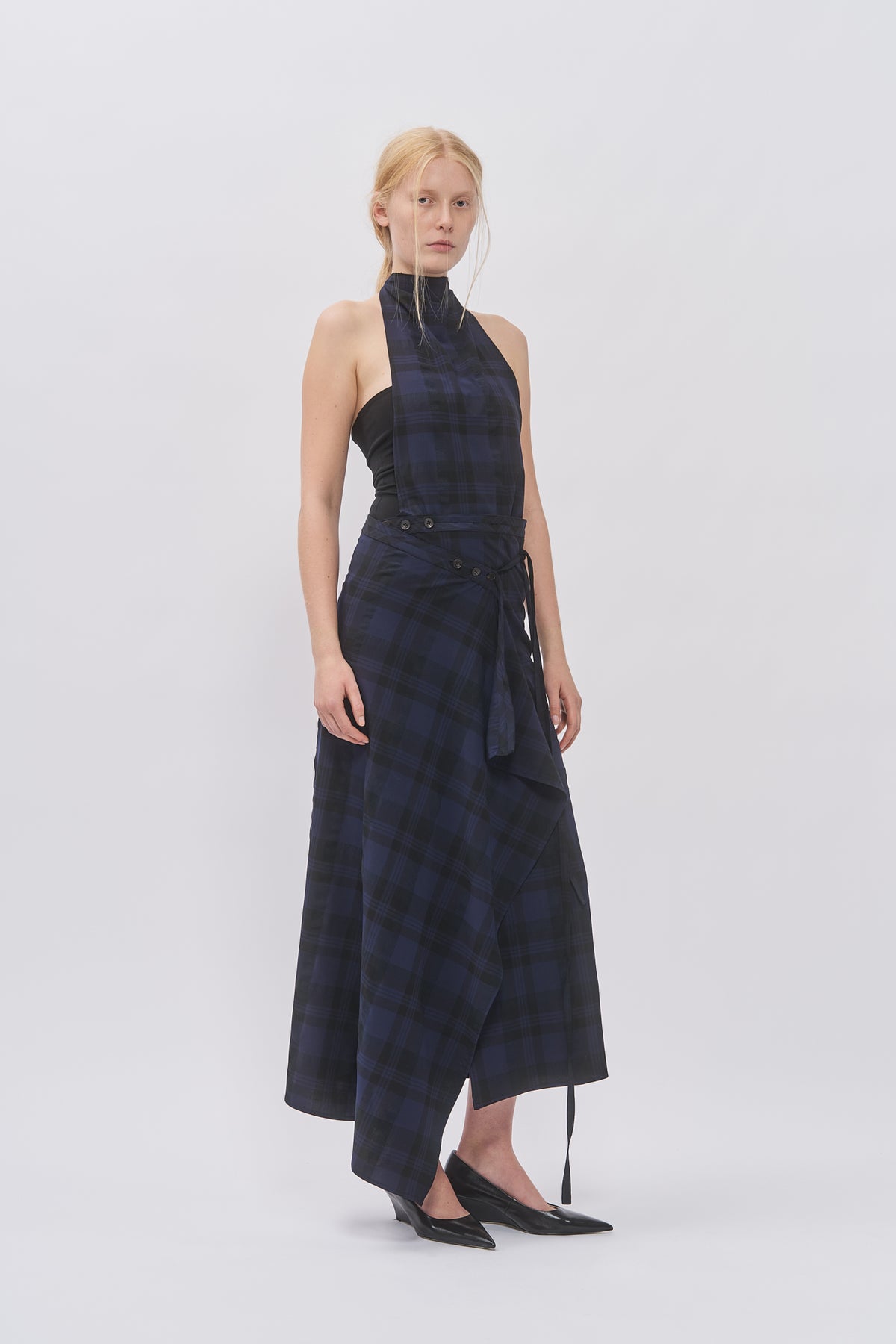 Taus Wrap Skirt in navy and black check with draped tie front, worn with the matching halterneck top